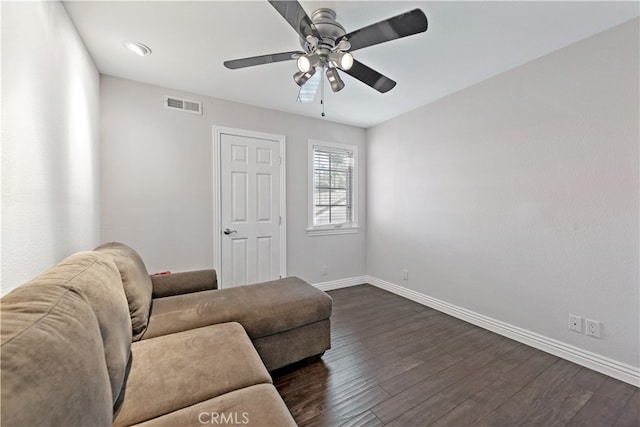 living room featuring dark hardwood / wood-style floors and ceiling fan