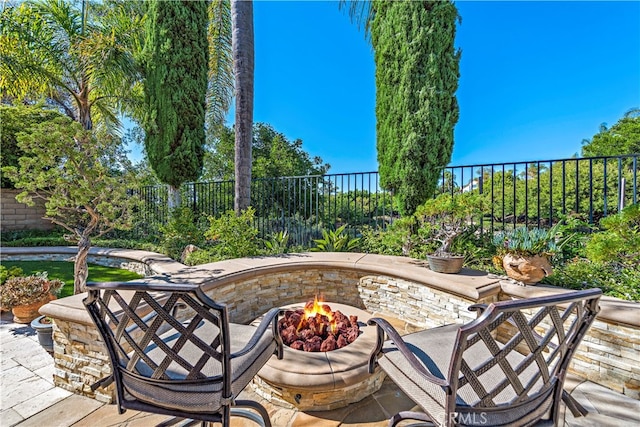 view of patio / terrace featuring an outdoor fire pit