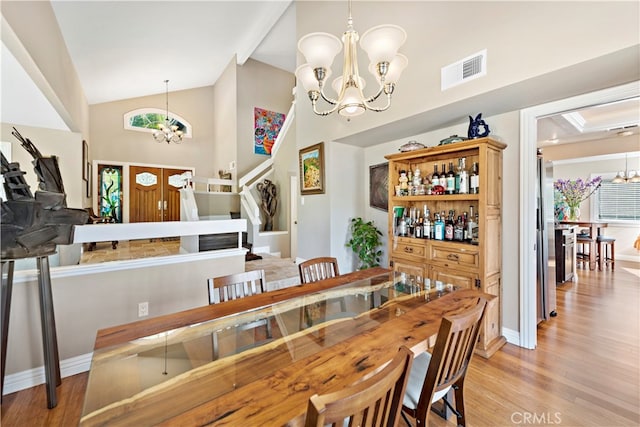 dining room featuring light wood-type flooring and a chandelier