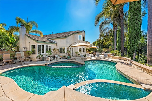 view of pool with a patio and an in ground hot tub