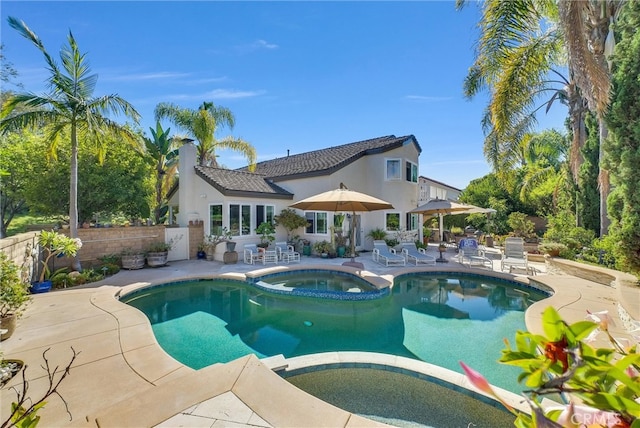 view of swimming pool with a patio and an in ground hot tub