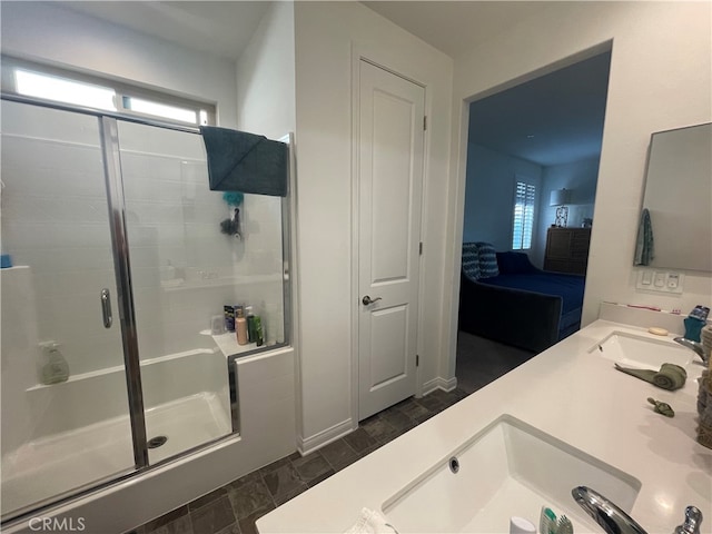 bathroom featuring dual sinks, tile patterned flooring, and an enclosed shower