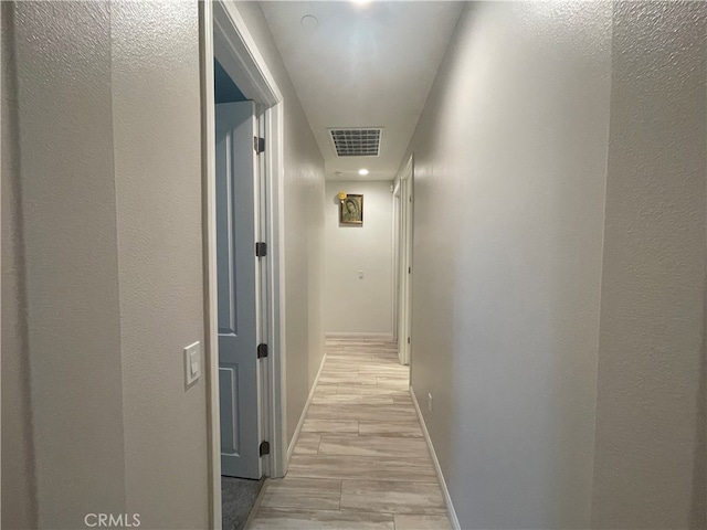 corridor with light hardwood / wood-style floors