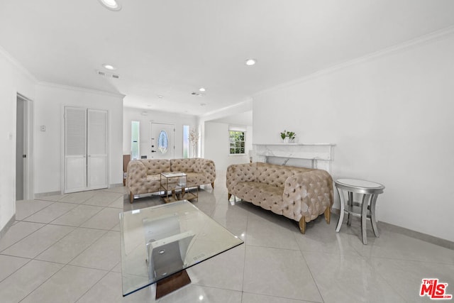 living room with crown molding and light tile patterned floors