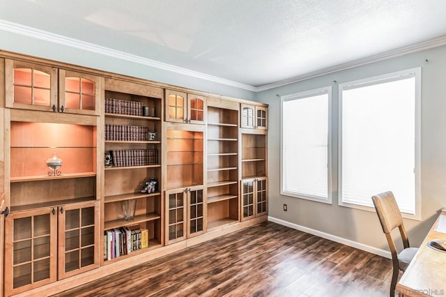 unfurnished office with dark hardwood / wood-style floors and crown molding