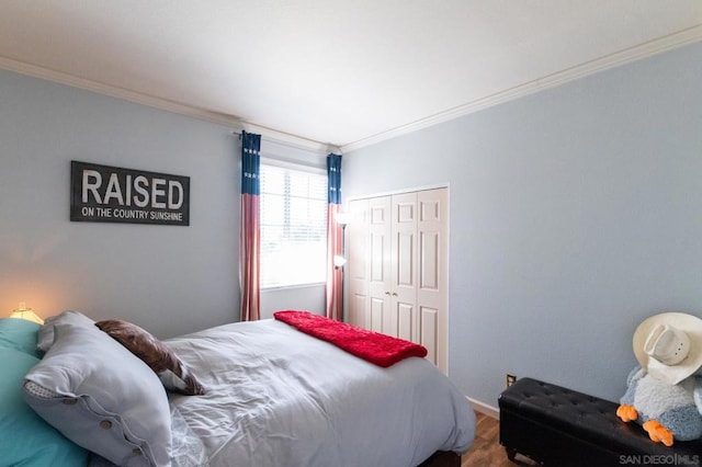 bedroom featuring a closet, crown molding, and wood-type flooring