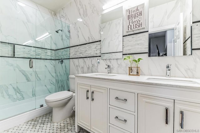 bathroom featuring a shower with shower door, toilet, and vanity