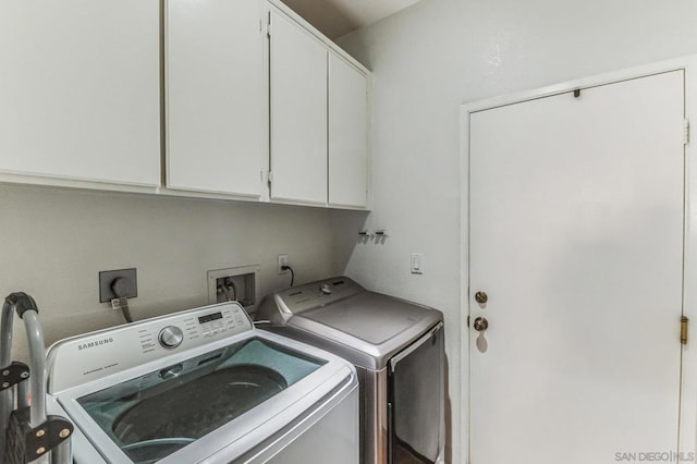 laundry area with cabinets and washing machine and dryer