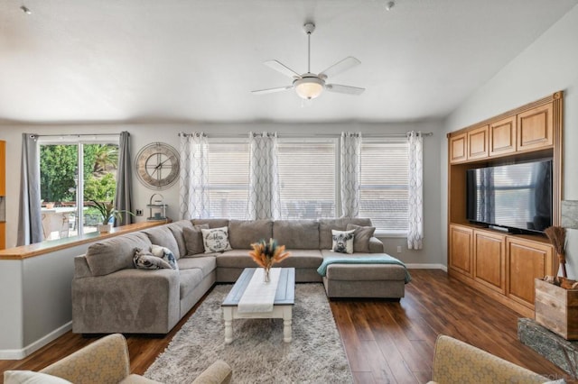 living room featuring ceiling fan, dark hardwood / wood-style floors, and lofted ceiling