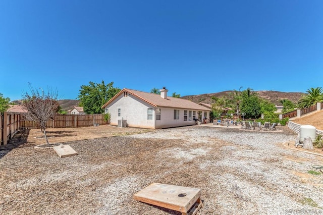 back of house with central AC unit and a mountain view