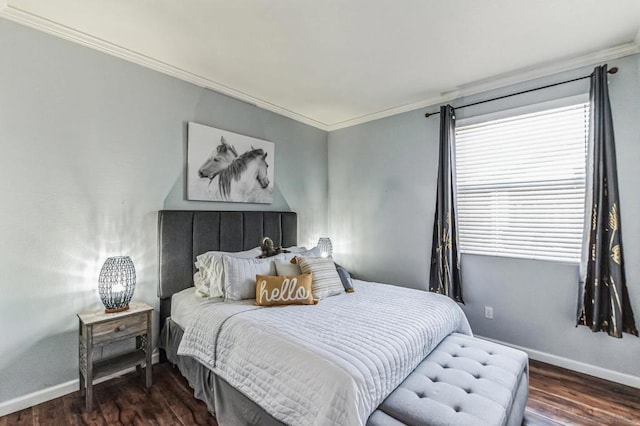 bedroom with dark hardwood / wood-style flooring and crown molding