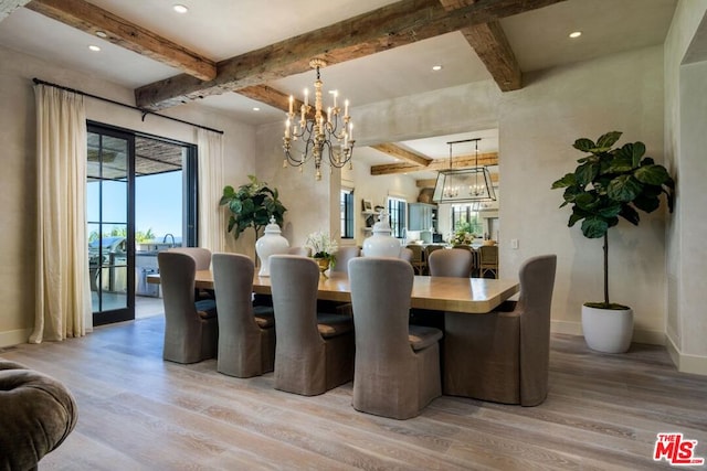 dining area featuring a notable chandelier, beamed ceiling, a healthy amount of sunlight, and light hardwood / wood-style floors