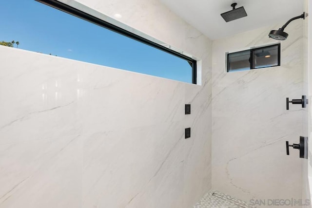 bathroom with tiled shower