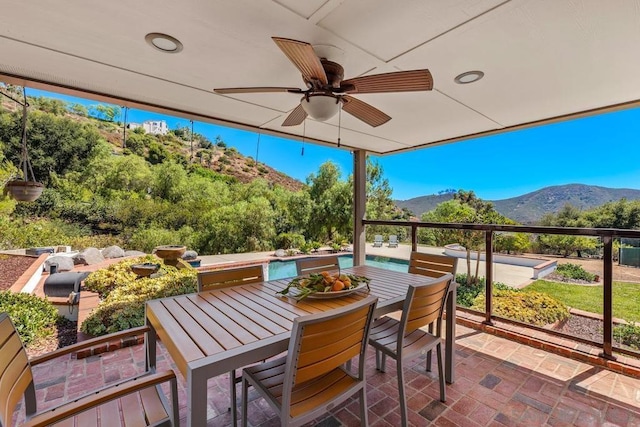 view of patio with ceiling fan and a mountain view