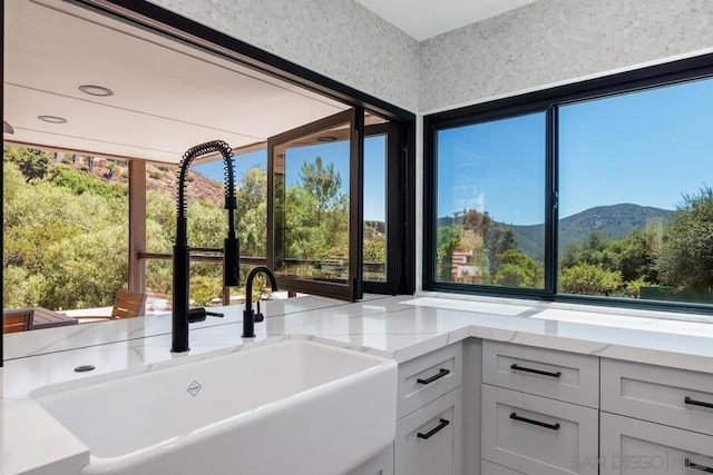 interior space with a mountain view and sink