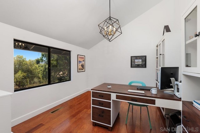 home office featuring an inviting chandelier, dark hardwood / wood-style flooring, and lofted ceiling