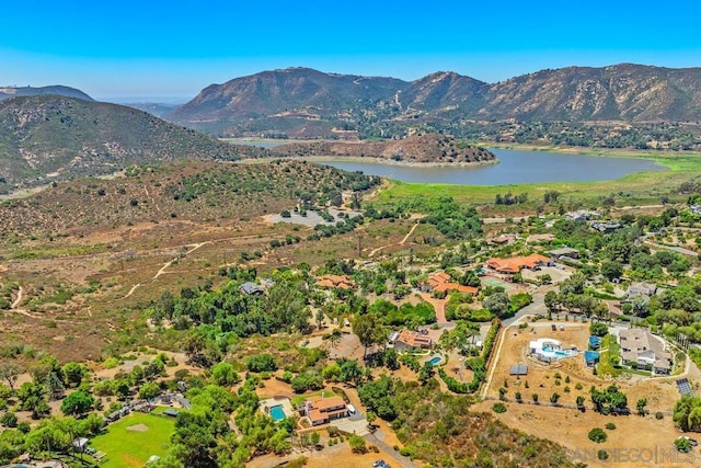 drone / aerial view featuring a water and mountain view