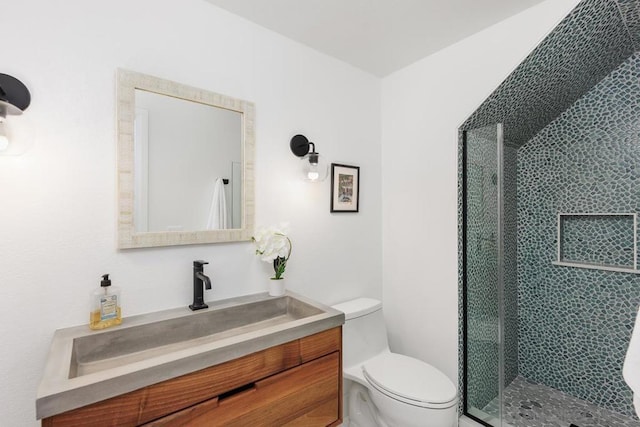 bathroom featuring toilet, walk in shower, and vanity