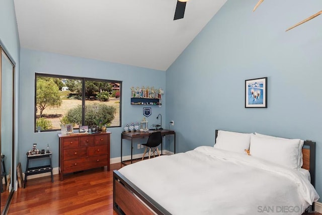 bedroom with ceiling fan, dark hardwood / wood-style floors, a closet, and lofted ceiling