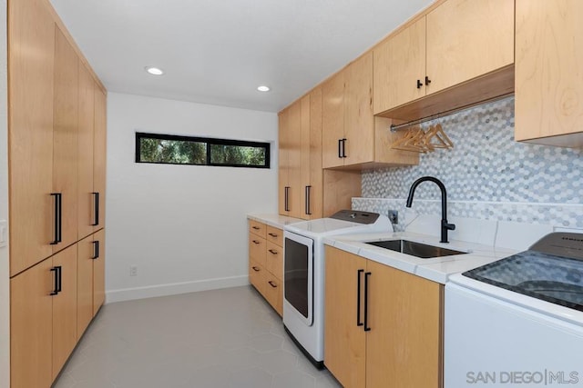 kitchen with tasteful backsplash, washer and dryer, sink, light tile patterned flooring, and light brown cabinets