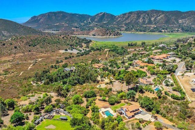 drone / aerial view featuring a water and mountain view