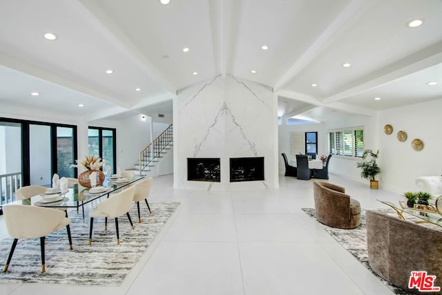 dining area with french doors, beamed ceiling, and light tile patterned floors