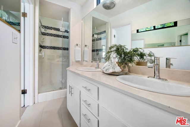 bathroom with tile patterned flooring, vanity, and an enclosed shower