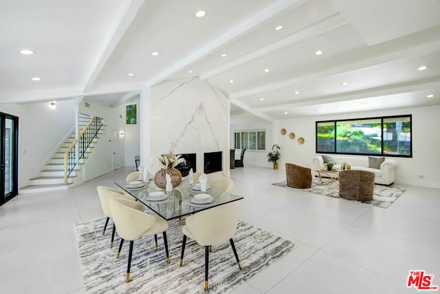 dining area with vaulted ceiling with beams