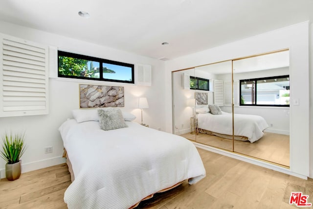 bedroom featuring light wood-type flooring and a closet