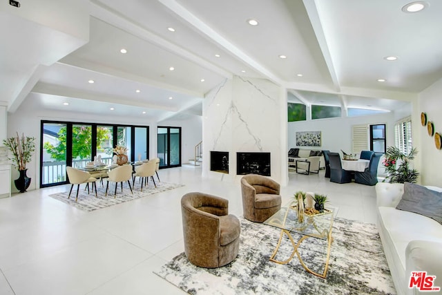 living room with beam ceiling and light tile patterned floors