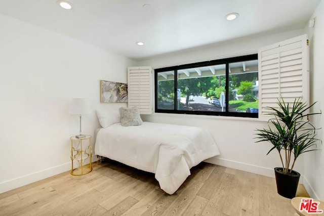 bedroom with light hardwood / wood-style floors