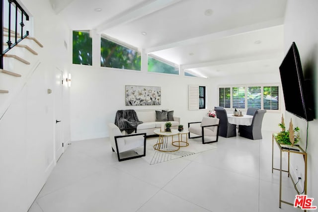 tiled living room with lofted ceiling with beams