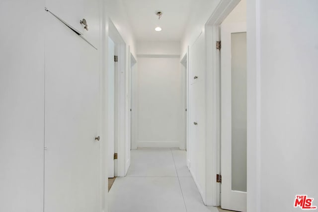 hall with light tile patterned flooring