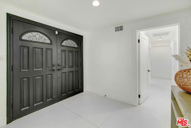 foyer featuring light tile patterned floors