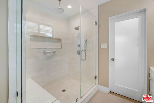 bathroom with tile patterned flooring and walk in shower