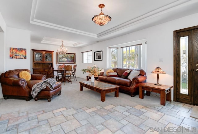 living room featuring a chandelier and a tray ceiling