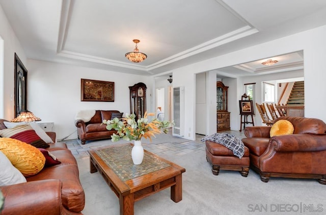 carpeted living room featuring a tray ceiling