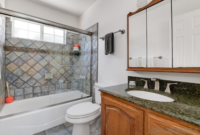 full bathroom with vanity, tile patterned flooring, toilet, and combined bath / shower with glass door