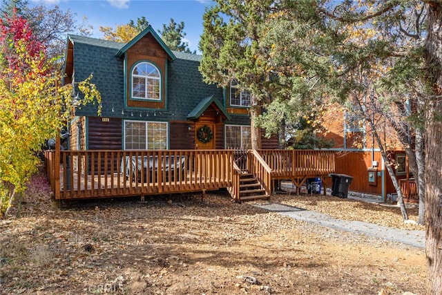 rear view of house featuring a wooden deck