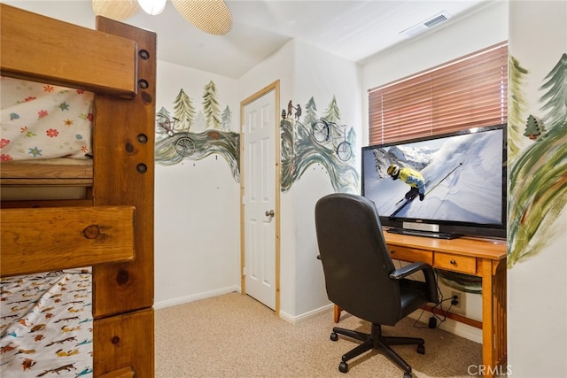 carpeted home office with ceiling fan