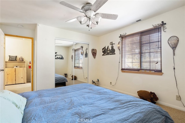 bedroom featuring ceiling fan, a closet, and carpet