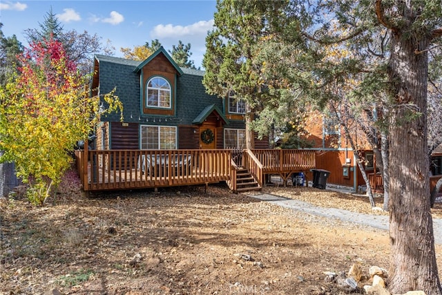 back of property with a wooden deck