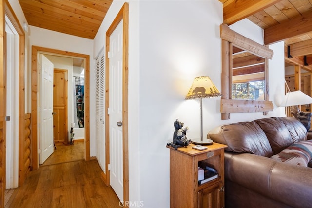 hallway with beam ceiling, wooden ceiling, and wood-type flooring