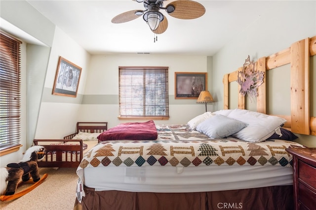 bedroom featuring ceiling fan and carpet