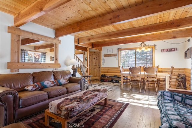 living room with beam ceiling, wooden ceiling, an inviting chandelier, and hardwood / wood-style flooring