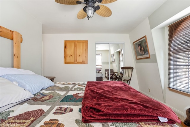 bedroom featuring ceiling fan, a closet, and multiple windows