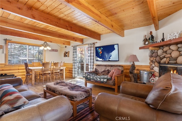 living room featuring a fireplace, beamed ceiling, log walls, a chandelier, and wooden ceiling