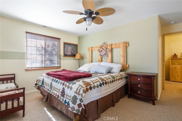 bedroom with ceiling fan and light colored carpet