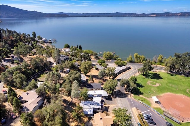 birds eye view of property with a water and mountain view