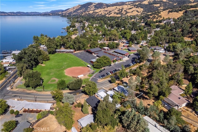 birds eye view of property with a water and mountain view